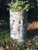 A cylindrical stone well head, carved with three coats of arms, H.4ft 3in. Diameter 2ft 7in.