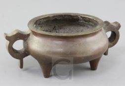 A Chinese bronze ding censer, probably 19th century, with a pair of looped handles to each side,