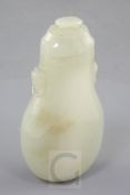 A Chinese pale celadon jade flattened baluster snuff bottle and cover, 19th century, the shoulders