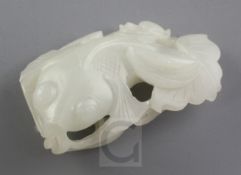 A Chinese white jade carving of a goldfish amid lotus, late 19th / early 20th century, the stone