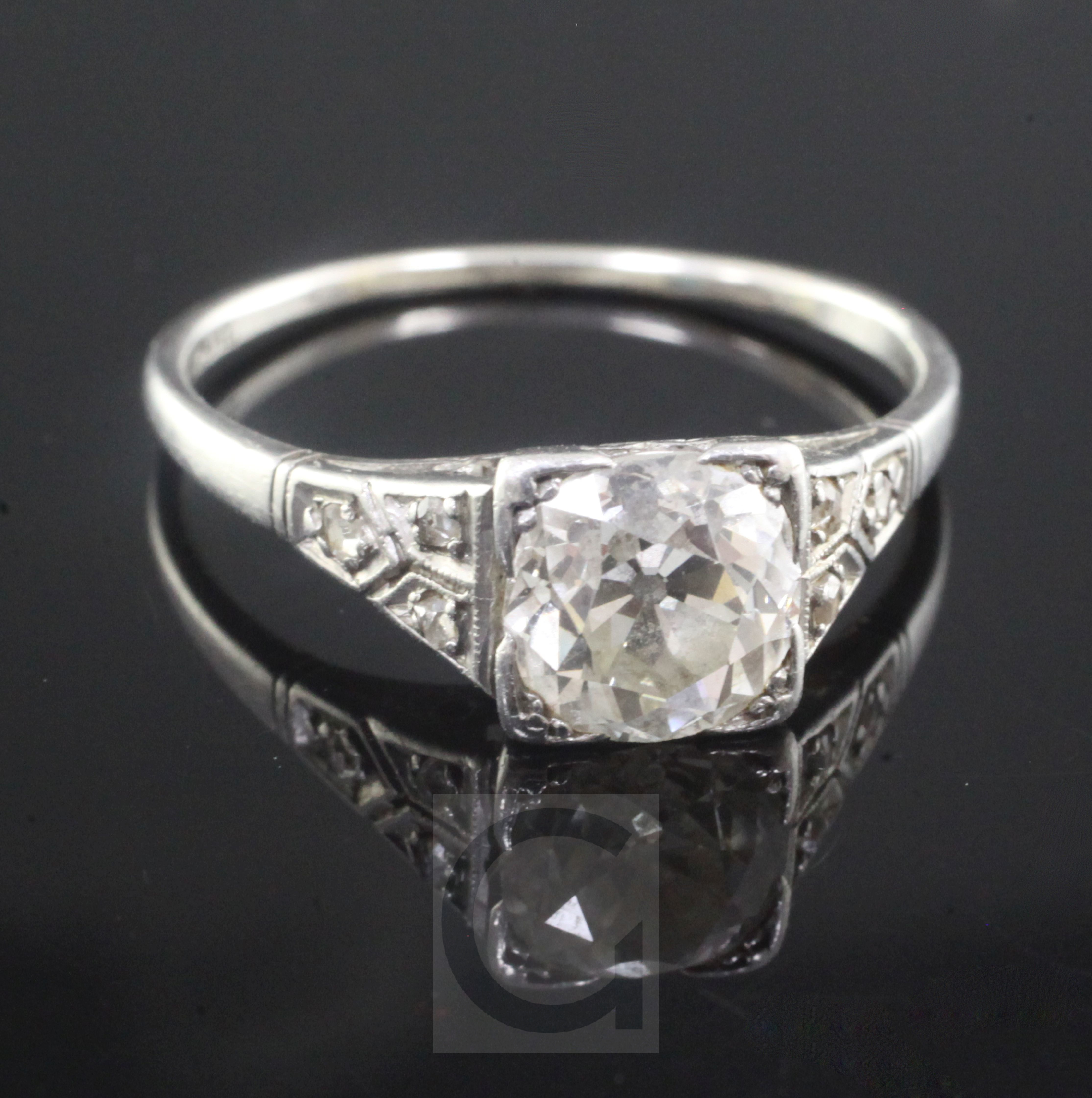 A 1920's/1930's platinum and single stone diamond ring with diamond set shoulders, the old round cut