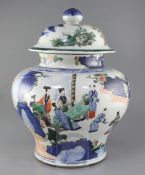 A massive Chinese wucai baluster jar and cover, early Kangxi period, c.1670, painted with a