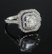 A white gold and single stone asscher cut diamond ring bordered with two concentric octagonal