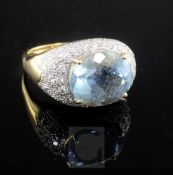 A modern 18ct gold, aquamarine and diamond cluster ovoid dress ring, size R.