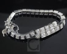 A 1930's/1940's platinum? and graduated diamond set line bracelet, set with thirty four old round