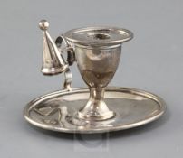 A George III Irish silver oval chamberstick, Dublin, 1804, with later associated extinguisher,