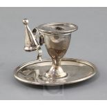 A George III Irish silver oval chamberstick, Dublin, 1804, with later associated extinguisher,