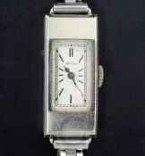A lady's late 1920's 9ct white gold Rolex manual wind rectangular cased wrist watch, with baton