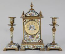 An early 20th century bronze and champleve enamel clock garniture, with architectural clock signed