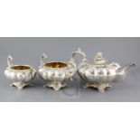 A George IV Irish silver melon shaped three piece tea set by Edward Crofton, with foliate borders