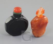 A Chinese chalcedony fruit form snuff bottle and a Chinese black glass watch-shaped snuff bottle,