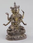 A Sino-Tibetan parcel gilt bronze seated figure of Avalokiteshvara, with three heads and eight arms,