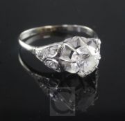 An 18ct white gold and single stone diamond ring with diamond set shoulders, the round cut stone