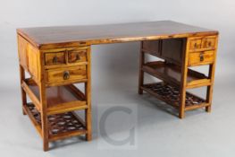 A Chinese huali and other hardwood pedestal desk, 19th century, fitted with an arrangement of six