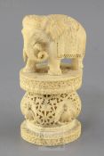 An Indian or Burmese ivory figure of an elephant, late 19th century, standing on an oval pedestal