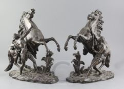 After Coustou. A pair of bronze Marli horse groups, 15in.
