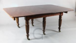 A Regency mahogany extending dining table with four leaves, on turned and fluted tapered legs L.