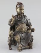 A Chinese polychrome decorated bronze seated figure of Guandi, probably Ming dynasty, the figure
