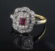 A mid 20th century 18ct gold, ruby and diamond cluster dress ring, of shaped rectangular form,