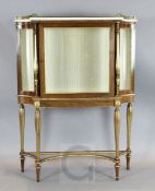 An early 19th century parcel gilt rosewood vitrine with white marble top, on slender baluster legs