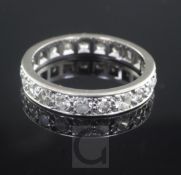 A white gold and diamond full eternity ring, set with twenty one round brilliant cut diamonds,