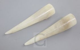 Two Chinese white and grey jade nail guards, of conical form open to one side, 7.6cm