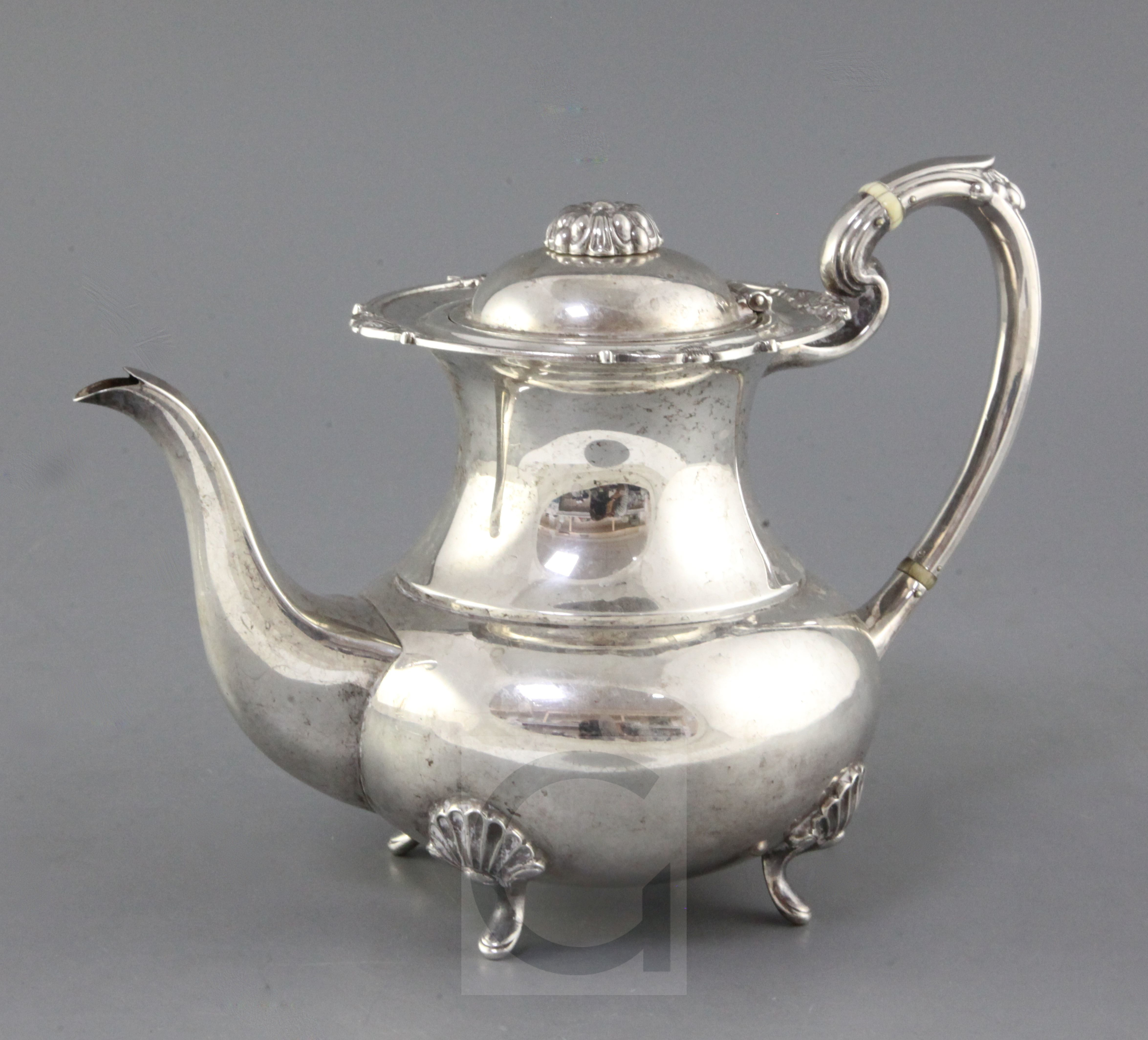 A late 1960's Garrard & Co Ltd silver coffee pot, of baluster form, with scroll handle and shell