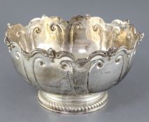 A late Victorian silver Monteith bowl, with mask and scroll border and engraved inscription, on