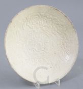 A Chinese qingbai 'phoenix and peony' dish, Yuan dynasty, moulded with phoenix amid peonies within a