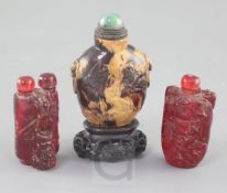 A Chinese amber snuff bottle and two cherry amber snuff bottles, 19th / early 20th century, the