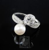 A platinum, cultured pearl and diamond set crossover ring with diamond set shoulders, the large