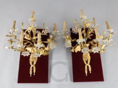 A pair of Napoleon III ormolu and Baccarat glass five branch wall lights, modelled as bunches of