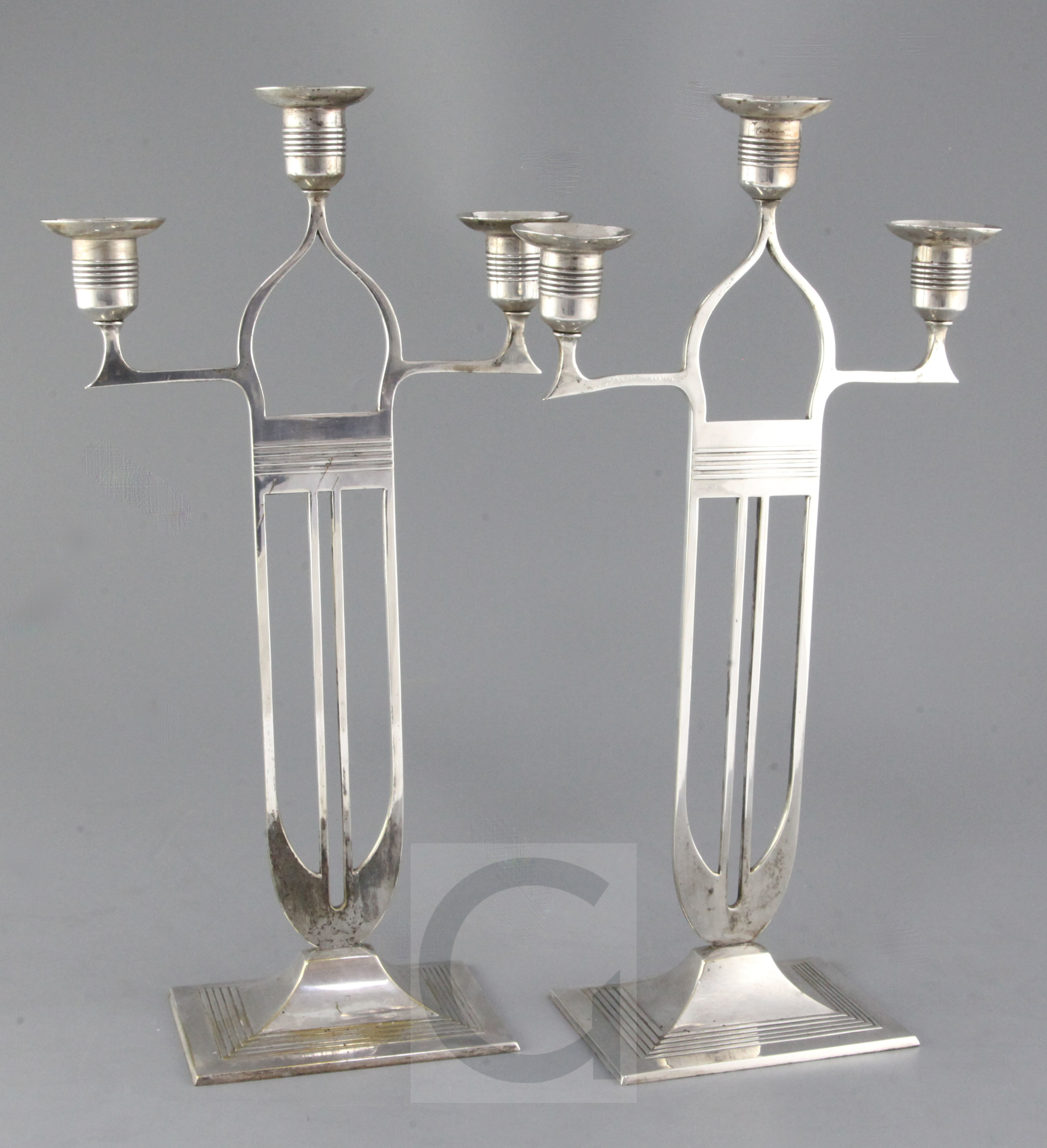 A pair of WMF Secessionist design silvered brass candelabra, height 16.5in.