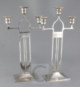 A pair of WMF Secessionist design silvered brass candelabra, height 16.5in.