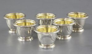 A set of six William IV silver egg cups by Paul Storr, with fluted spiral decoration, engraved crest