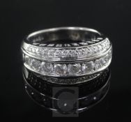 A modern 18ct white gold and triple row diamond half hoop dress ring, with an estimated total