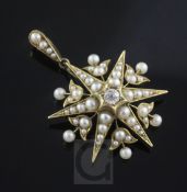 An Edwardian gold, split pearl and diamond set starburst pendant, 42mm.