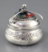 An Edwardian Arts & Crafts planished silver and enamel circular box and cover by Ramsden and Carr,