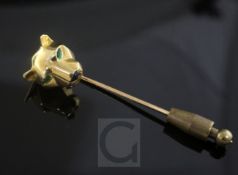 A Cartier 18ct gold, emerald and black onyx set Panther head stock pin, with emerald set eyes and