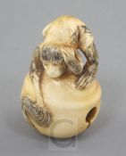 A Japanese ivory netsuke, carved with a monkey crouching on a bell, late 19th/early 20th century