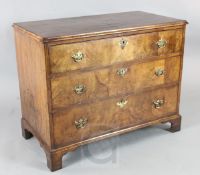 A George II walnut chest of three long drawers, on bracket feet 3ft3in. D.1ft9in. H.2ft7in.