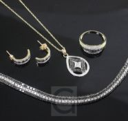 A 9ct gold and two colour diamond suite of jewellery, comprising a line bracelet, ring, pair of