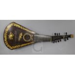 A Regency guitar lute, by Barry, London, c.1820, gilt decorated on the black japanned table, ten