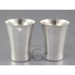 A pair of modern planished silver beakers by Simon J. Beer, (Lewes maker), with flared rims,