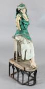 Manner of Louis Hottot. A painted spelter model of an Arab dancing girl leaning against a table,