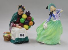 A Royal Doulton figure "Autumn Breezes", two figures "The Old Balloon Seller" (3)