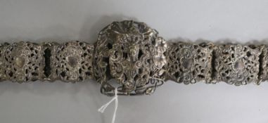 A silver plated nurses belt, decorated with mask and scrolls, 72cm