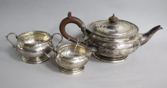 A George V silver three piece tea set by William Neale Ltd, Birmingham, 1926, and a pair of plated