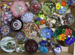 A large collection of glass paperweights