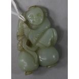 A green jade carving of boy with fruit